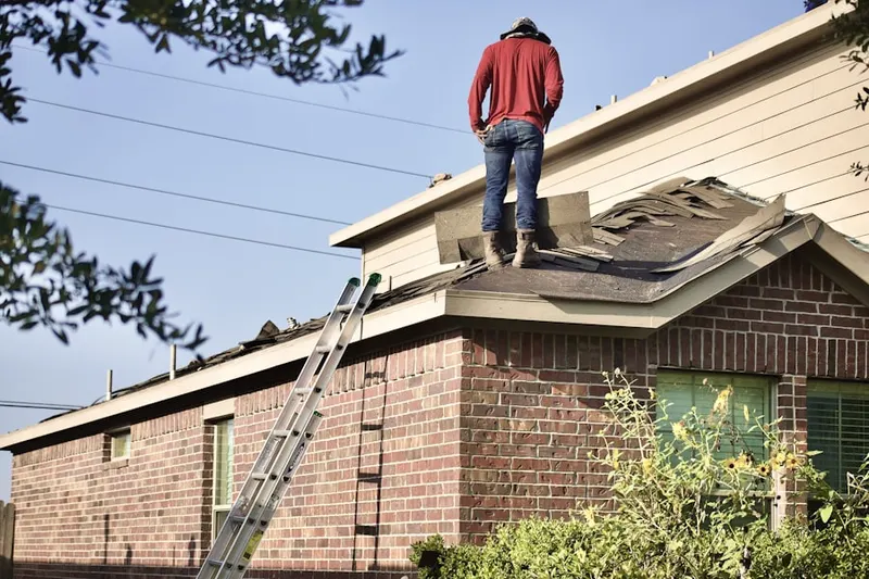 Professional roofer working on a residential roof in Spirit Lake